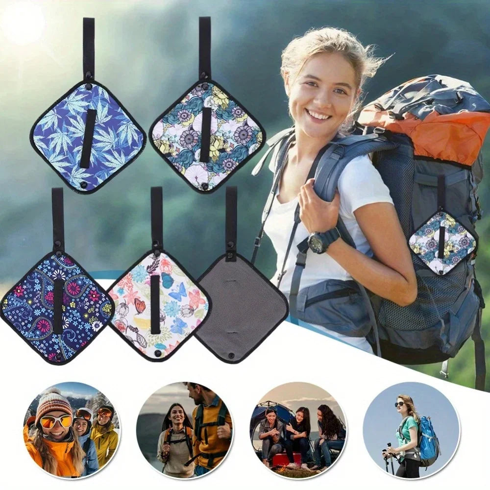 Woman with a backpack holding a floral-patterned bag, surrounded by various floral-patterned bags.
