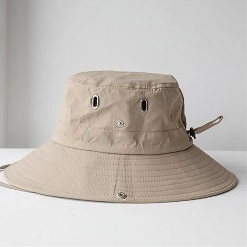 Beige bucket hat on a white surface with a light gray background