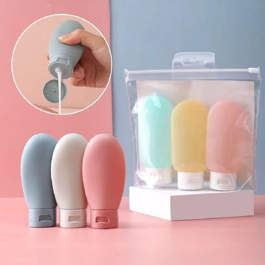 Set of colorful small bottles with a clear packaging box on a pink background