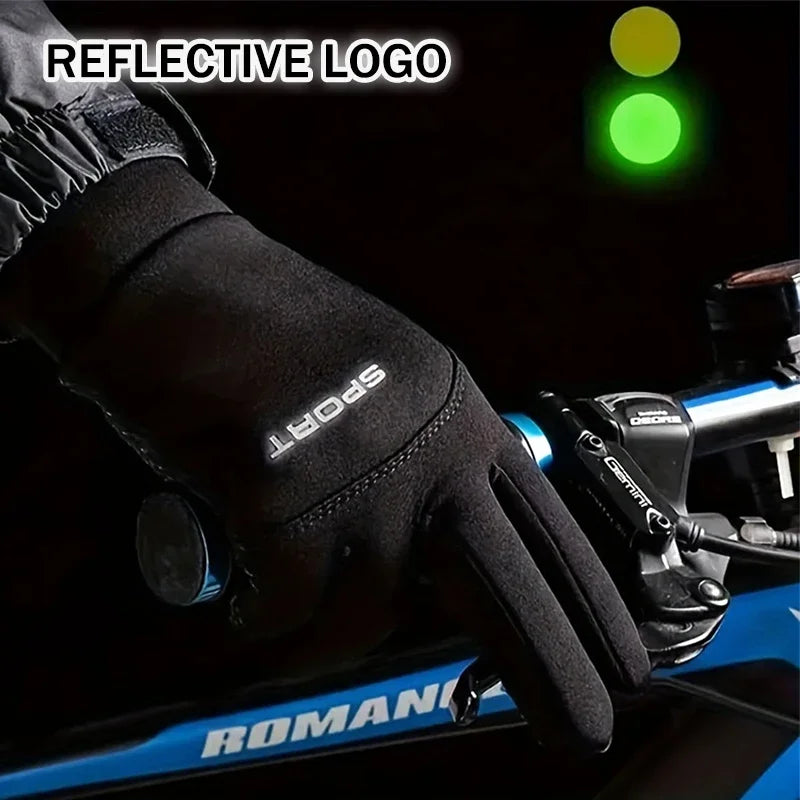 Black glove with reflective logo on a bicycle handlebar, traffic lights in the background.