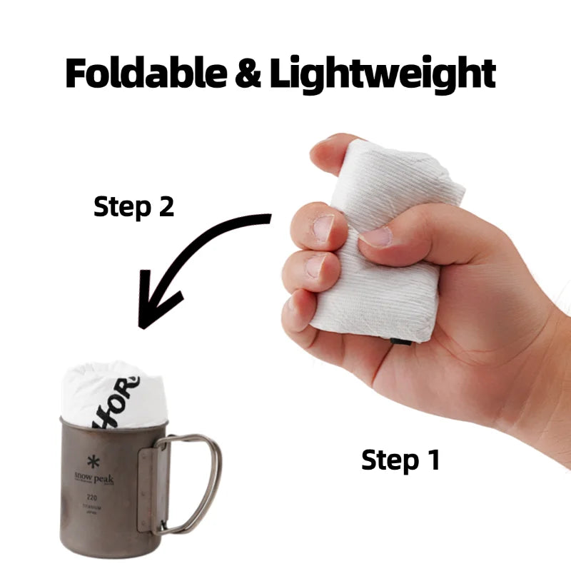 Foldable and lightweight product being demonstrated with a hand holding it and a mug in the foreground.