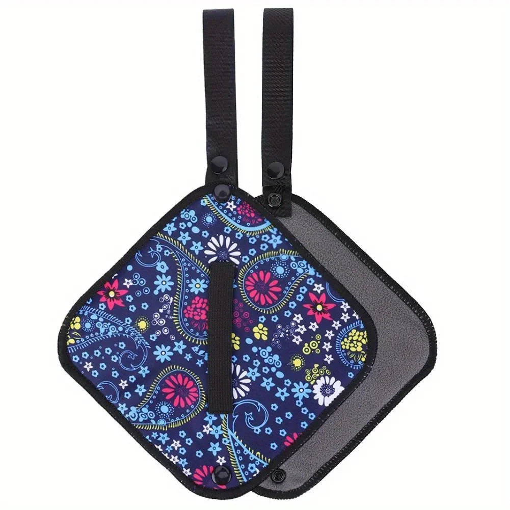 Colorful floral-patterned car seat cover with black straps on a white background