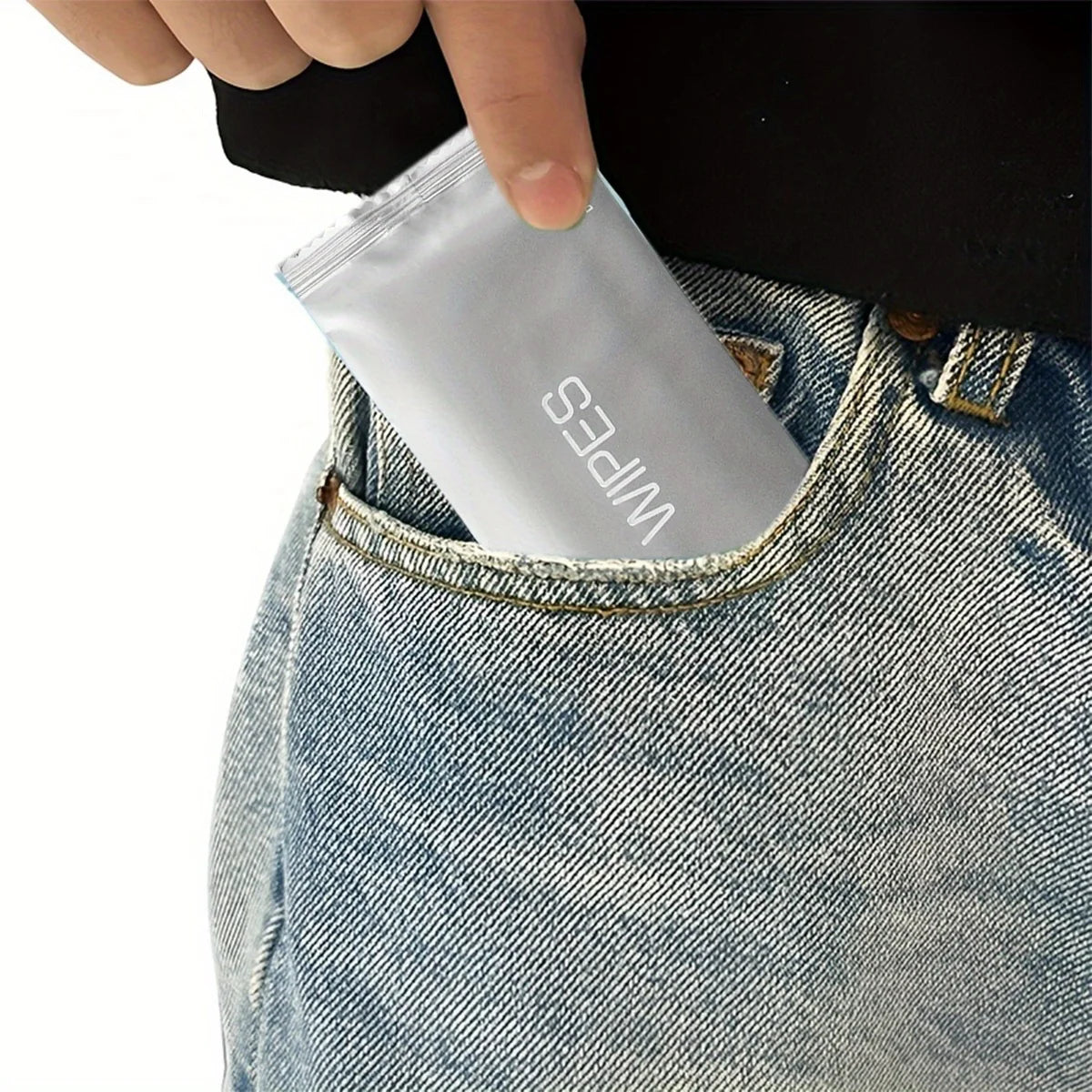 Person putting a packet of wipes into their pocket