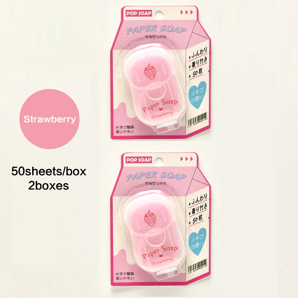 Two packages of Pop Soap strawberry paper soap on a light pink background