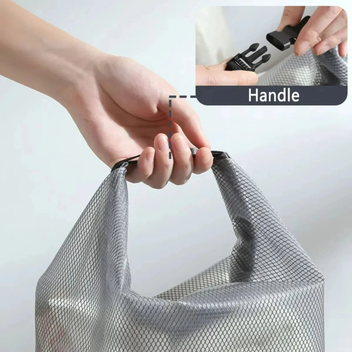 Gray mesh bag with handle being held, inset showing close-up of handle.
