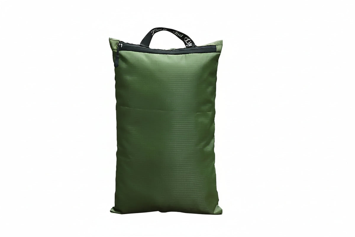 An olive green waterproof packing cube with a top zipper and carry handle, featuring a white airplane graphic and the text 'Enjoy a wonderful life ENT Weekdays' on the front, set against a plain white background.