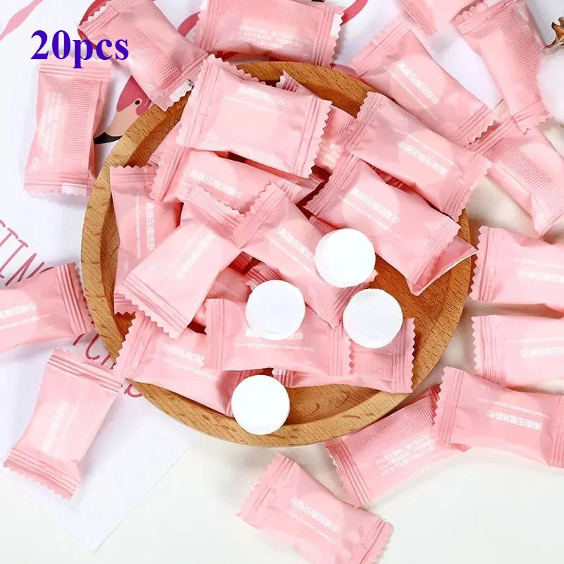 Pink packets with white capsules on a wooden plate, with '20pcs' text at the top.