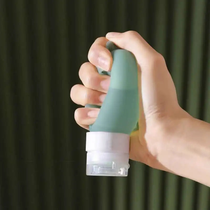 Hand holding a green and white handheld device against a dark green curtain background