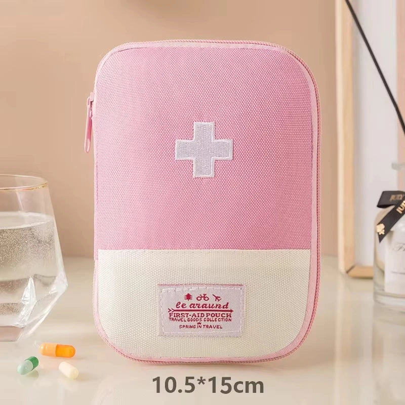 Pink first aid kit with a white cross on a beige background