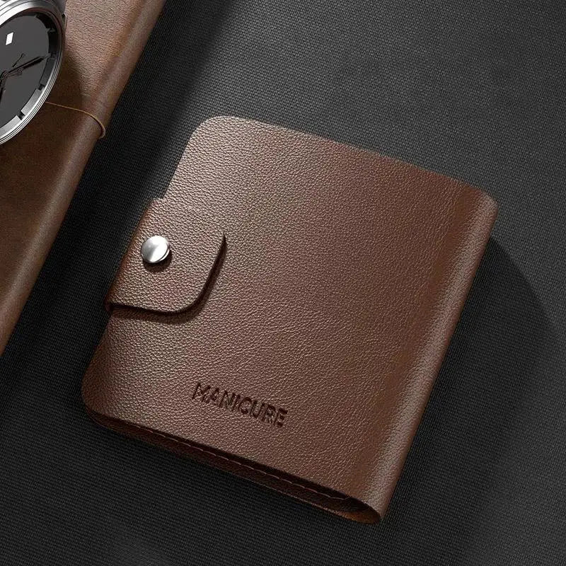 Brown leather wallet with 'Manicure' branding on a dark surface
