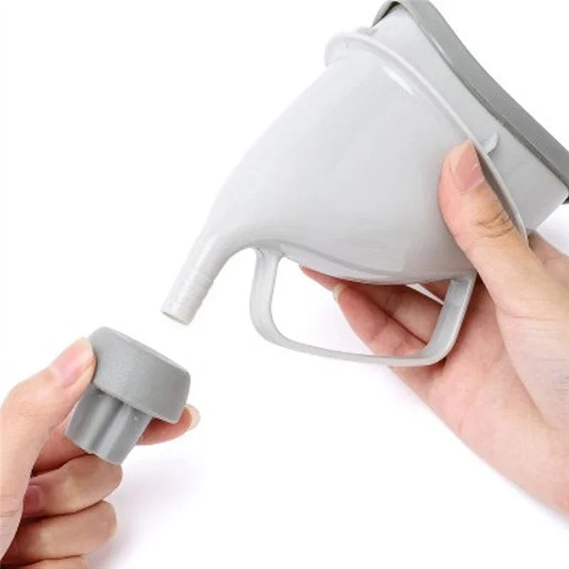 Gray funnel with handle held by a hand on a white background