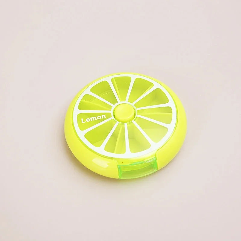 A round, lime-yellow lemon-shaped organizer with white segmented details and the word 'Lemon' printed on the side, set against a plain light beige background.