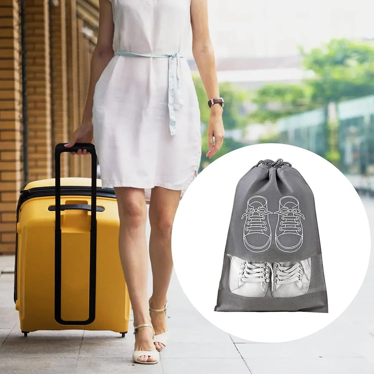Woman with a yellow suitcase and a gray shoe bag with white sneakers on a blurred background