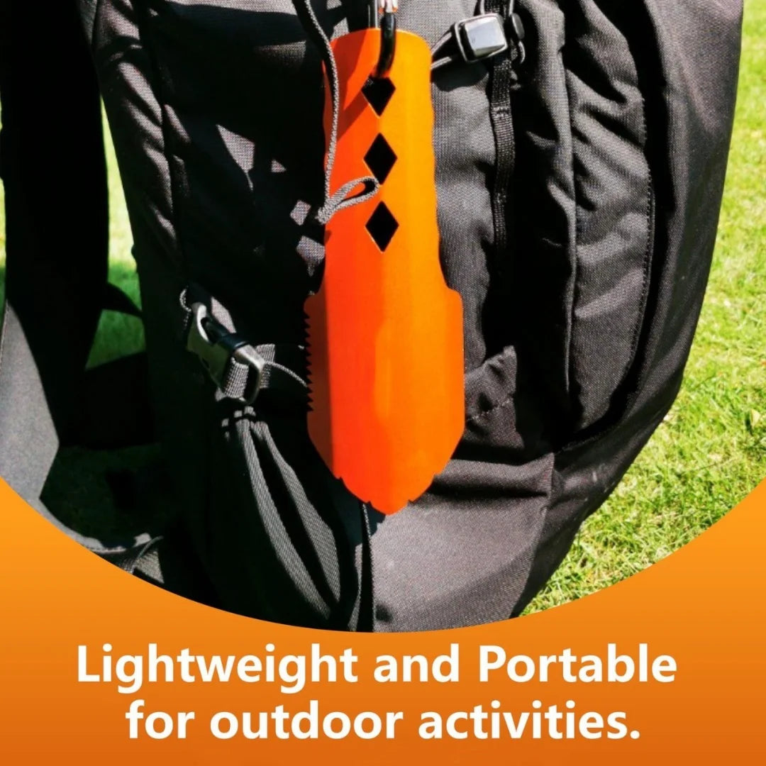 Orange Trowel with black diamond pattern attached to a black backpack on grass.