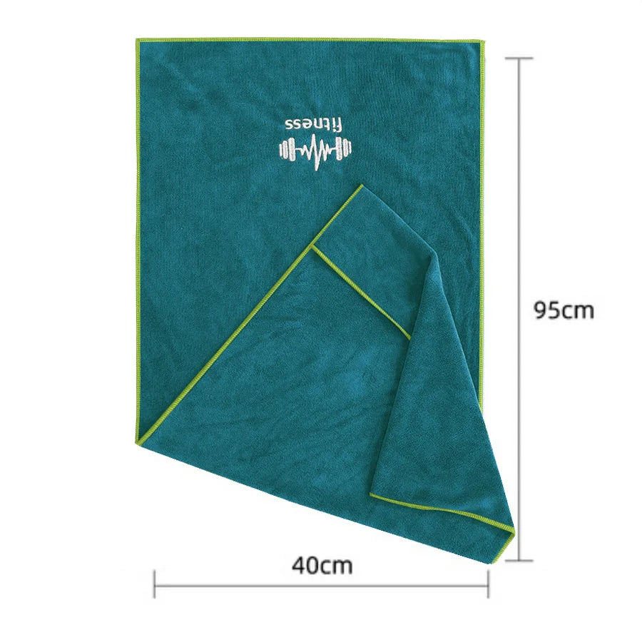 Teal towel with green trim, displayed with dimensions on a white background