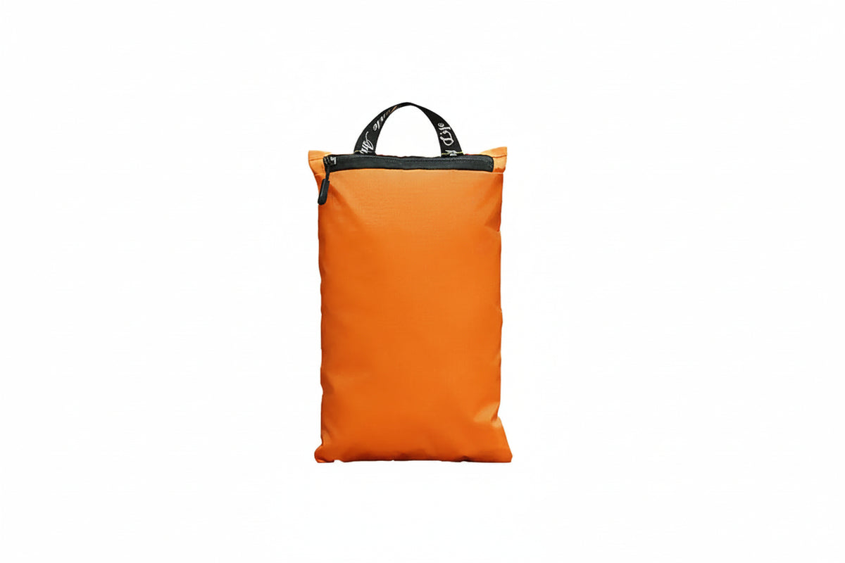 An orange zippered travel pouch with a black top handle and white printed text and airplane graphic on the front, shown against a plain white background.
