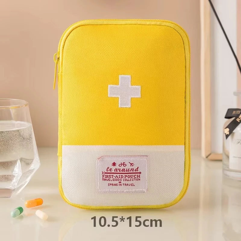 Yellow first aid pouch with a white cross on a beige surface