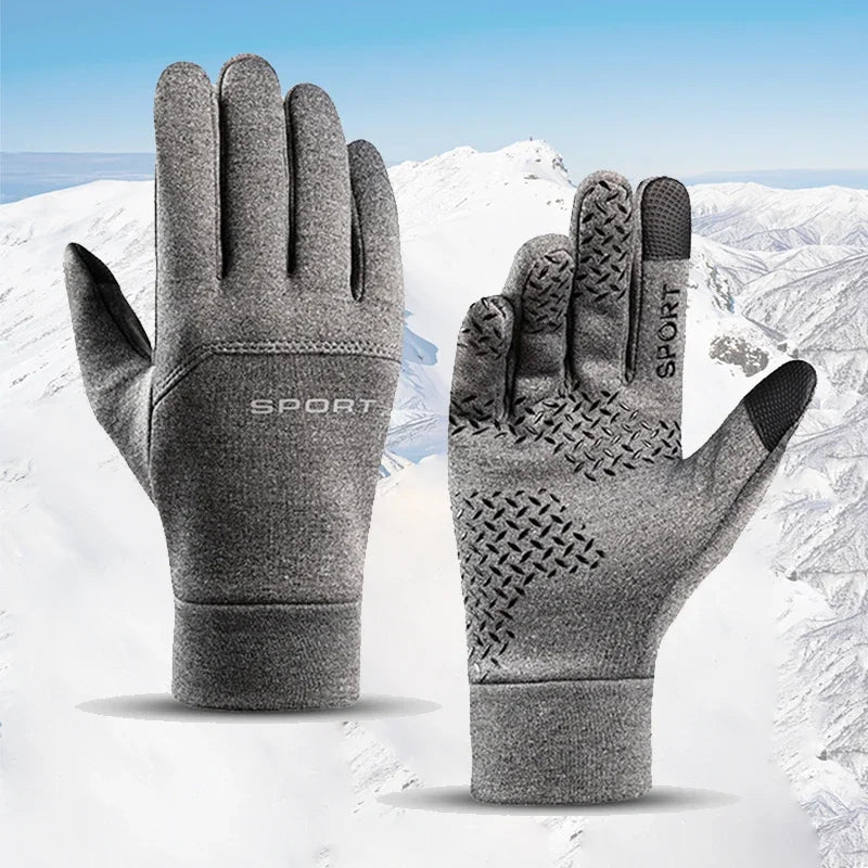 Gray touchscreen gloves with textured palm on a snowy background