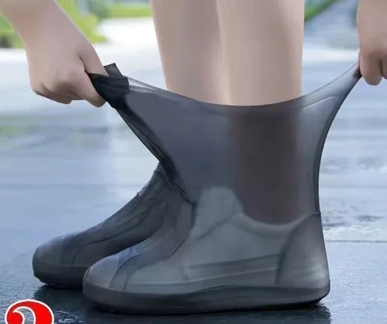 Person wearing a gray rain boot on a wet pavement