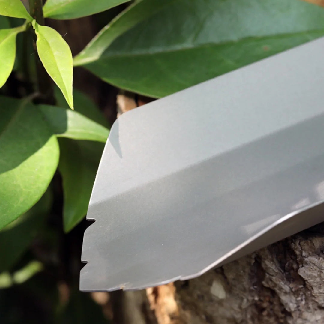 Close-up of ultralight backpacking trowel blade edge against a natural background.