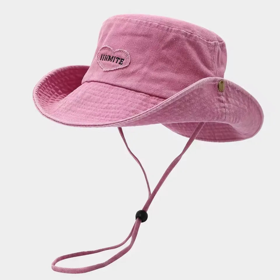 Pink sun hat with a strap on a light gray background