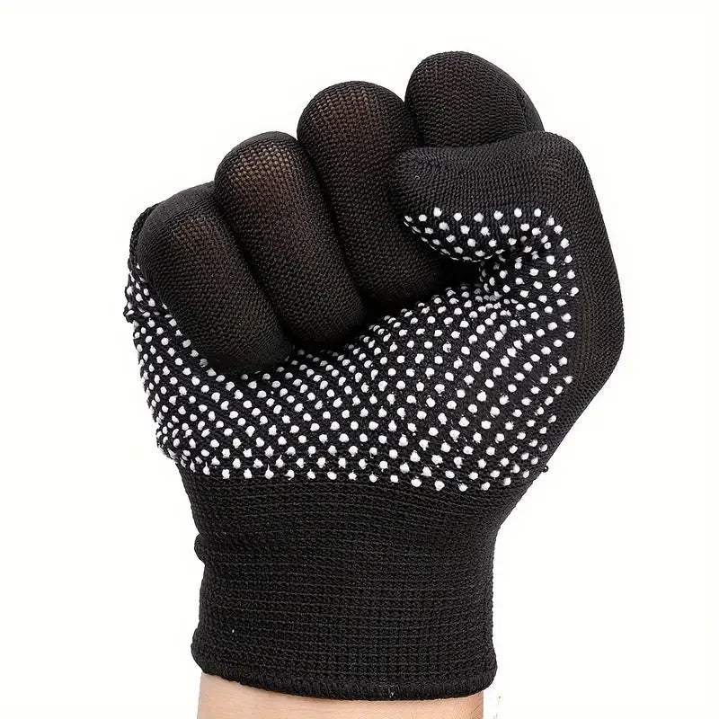 Black glove with white grip dots on a white background