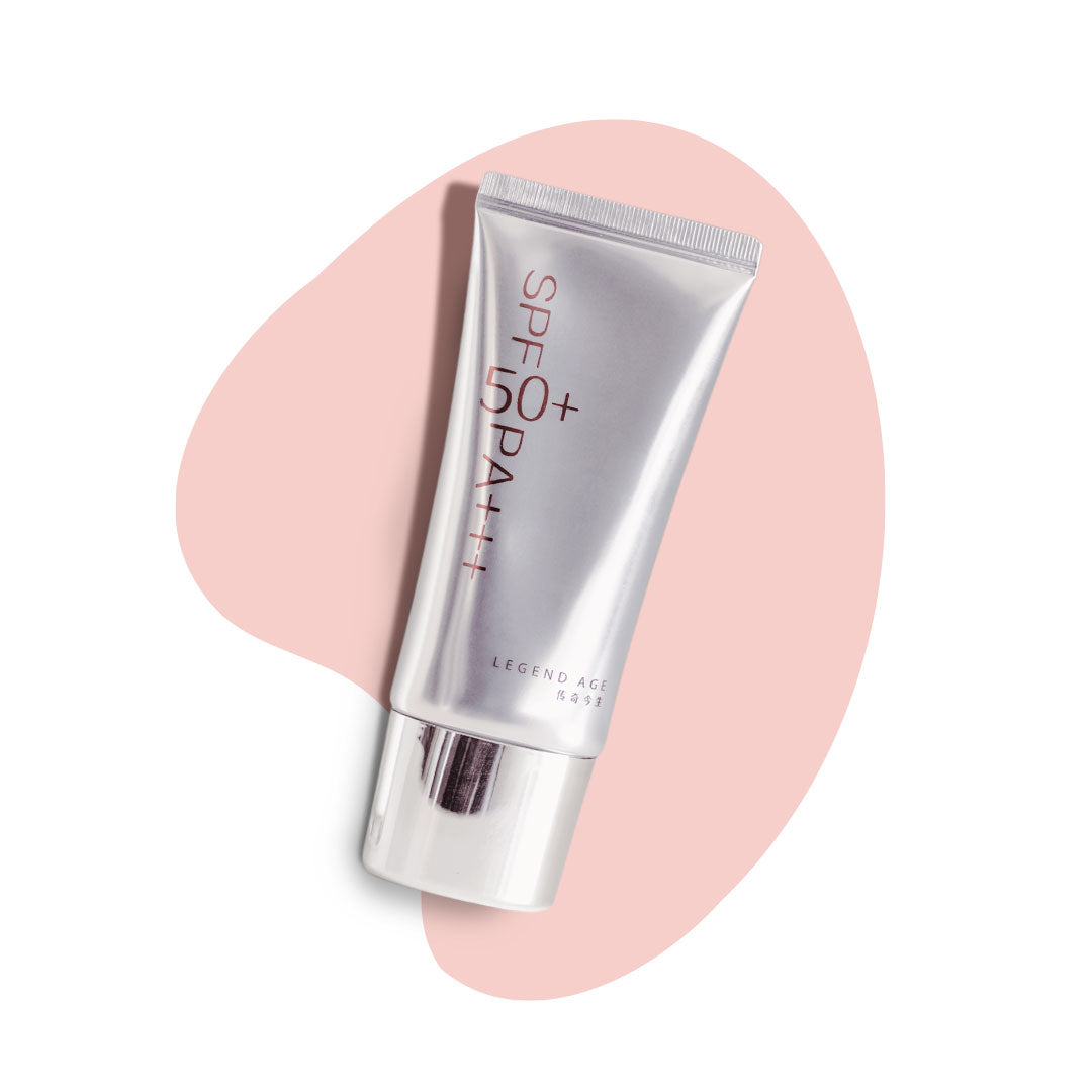 Silver skincare tube with 'SPF 50' on a pink heart-shaped background