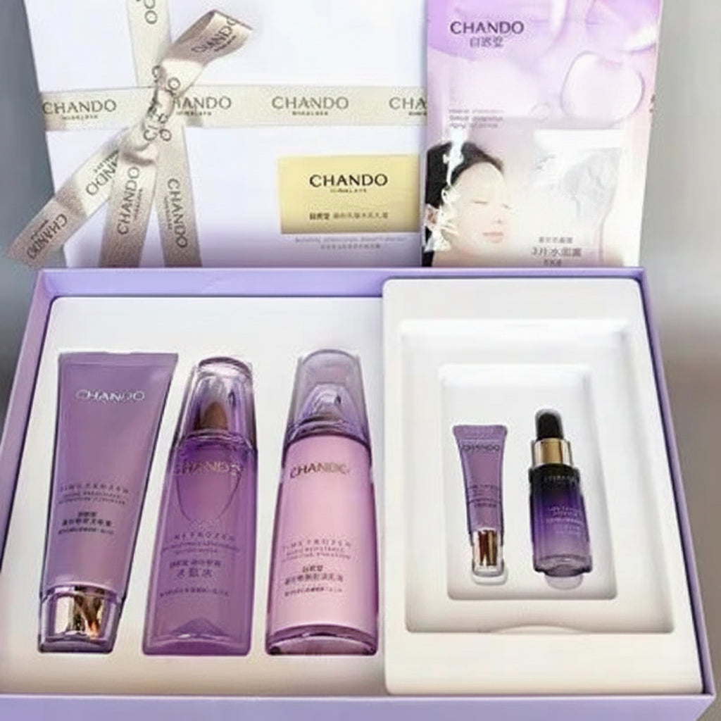CHANDO facial care gift set in a light purple box, containing a cleansing cream tube, toner bottle, moisturizer bottle, and eye cream dropper bottle, with the product packaging and ribbon box shown behind it.