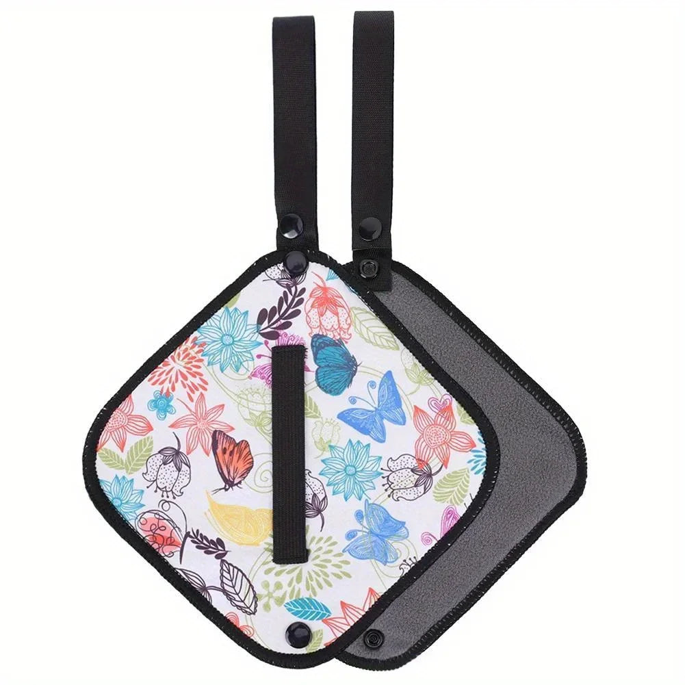 Colorful floral and butterfly patterned car seat cover with black straps on a white background