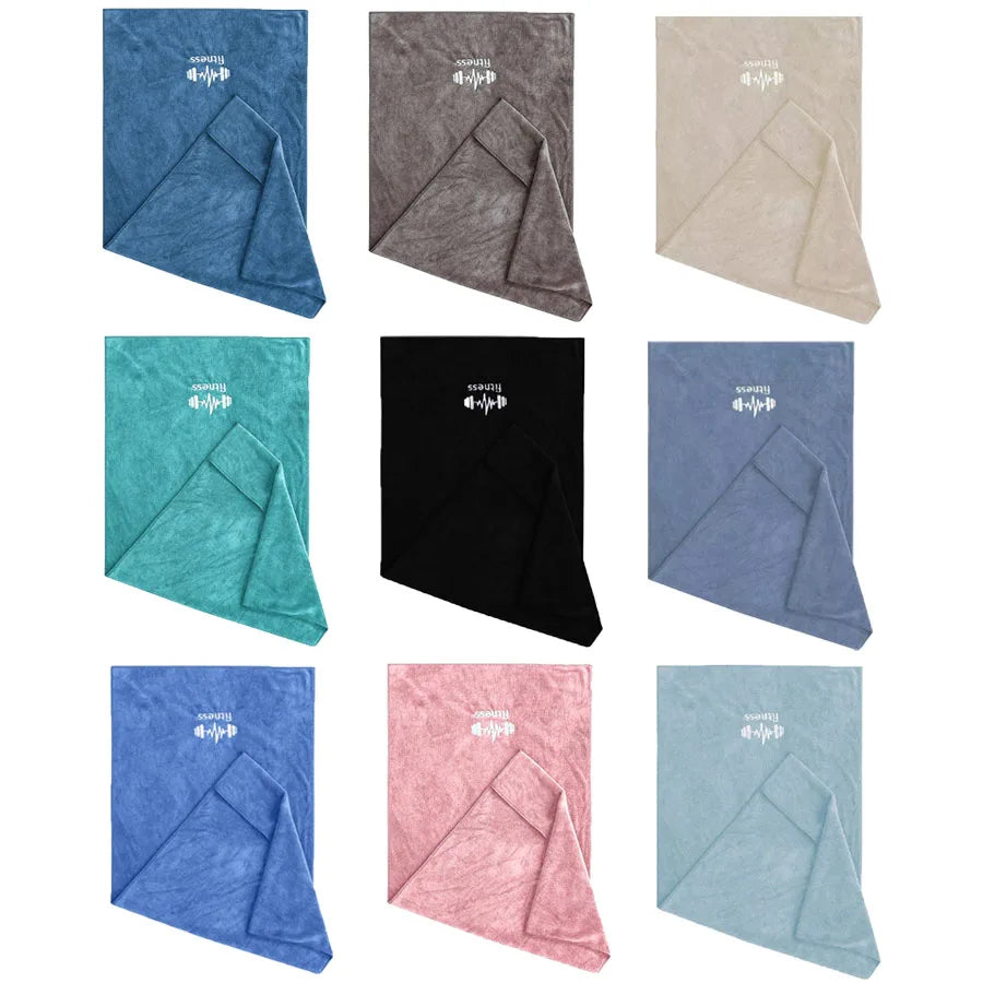 Collection of folded towels in various colors on a white background
