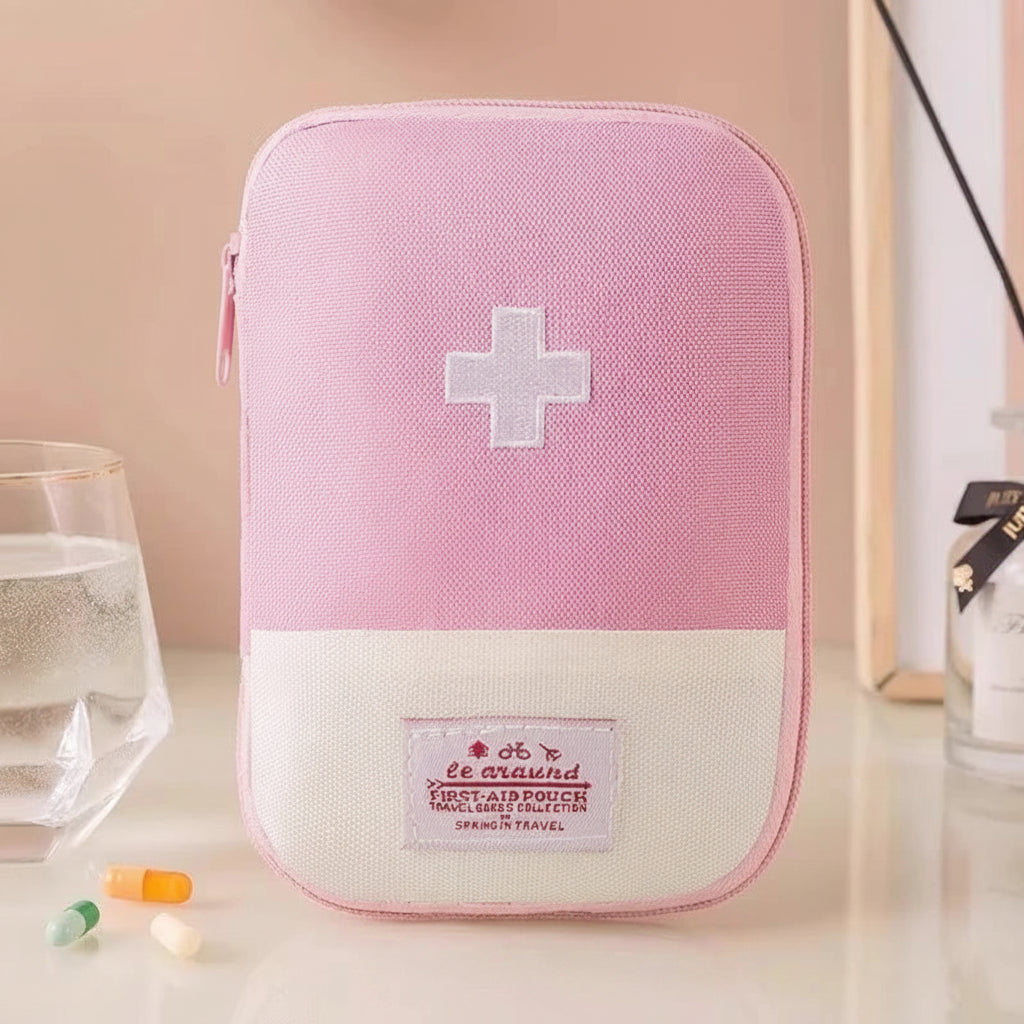 Pink first aid kit with a white cross on a beige background