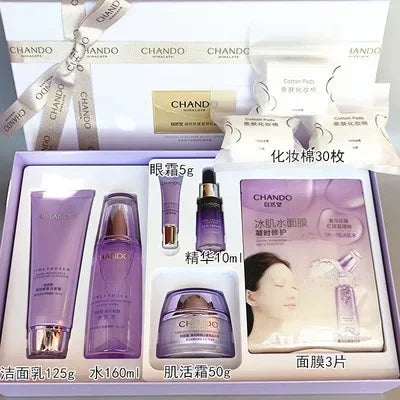 CHANDO skincare gift set in a light purple box, containing a purple cleanser tube, water bottle, eye serum, cream, and mask jar, with a model photo on the mask packet.