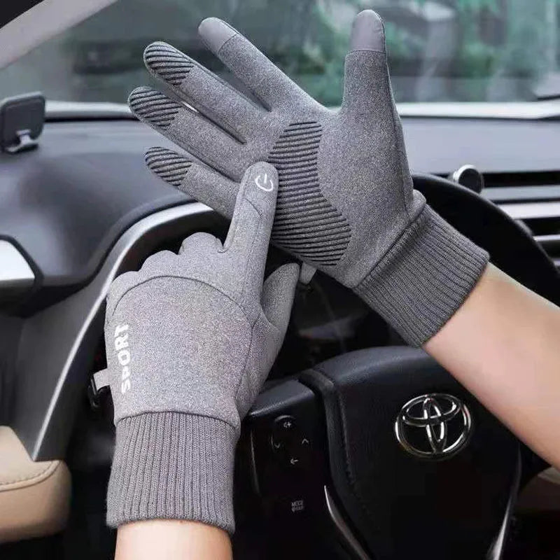 Gray touchscreen gloves being worn inside a car with a Toyota logo.