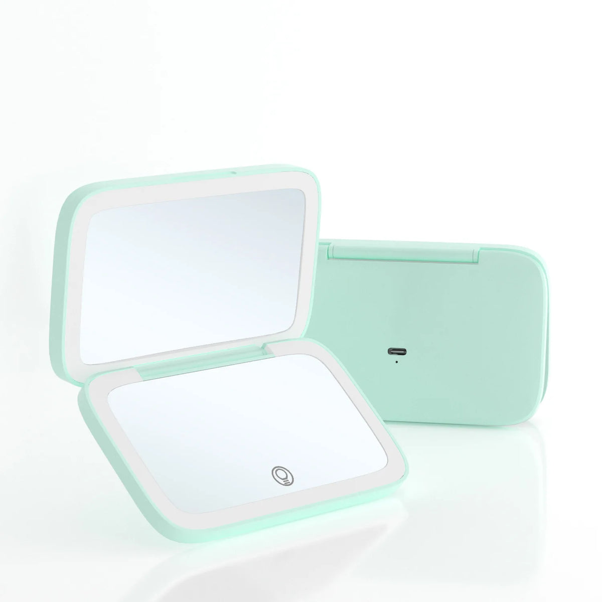 A mint green portable folding mirror compact shown open in front and closed behind it on a clean white background.