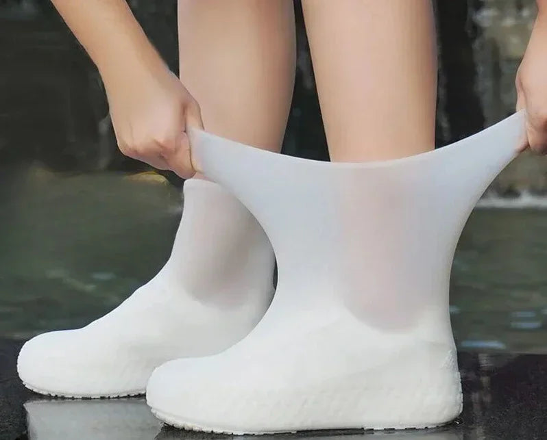White rubber boots being worn on a wet surface