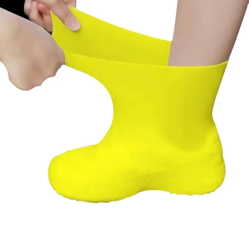 Yellow rubber shoe cover being put on a foot against a white background