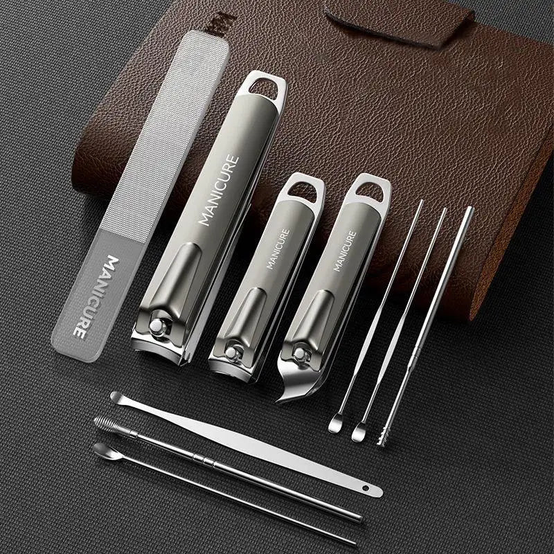 Set of manicure tools including nail clippers and cuticle nippers on a dark surface with a brown leather case.