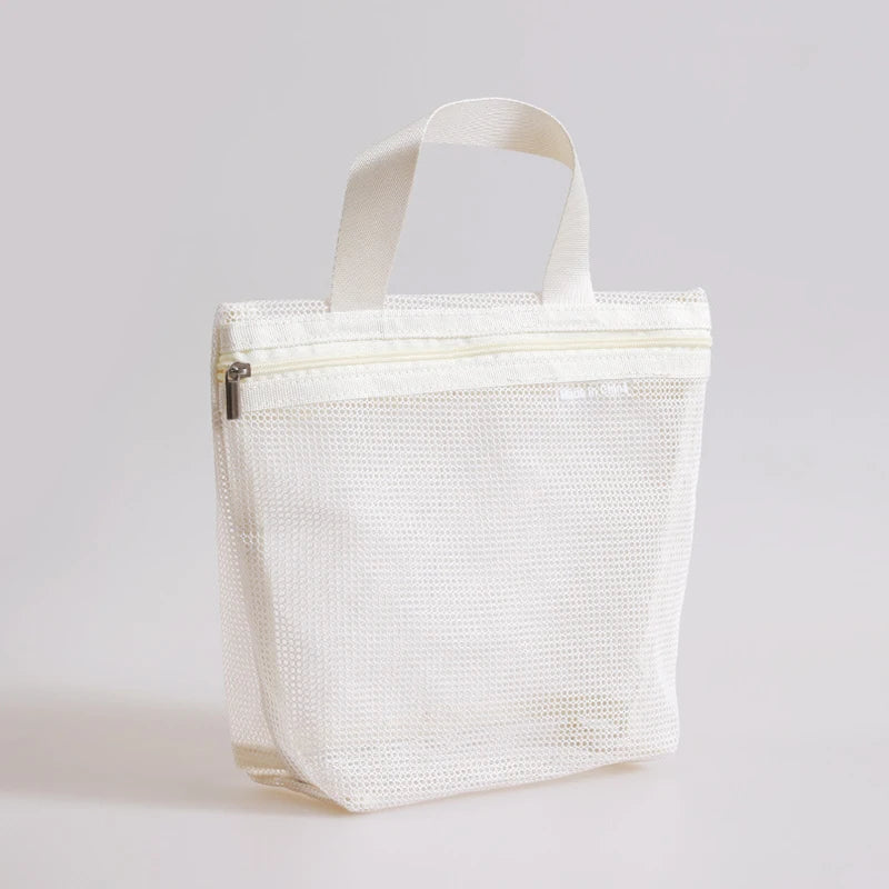 An off-white mesh laundry bag with two top handles and a zipper closure, shown on a neutral light gray background.