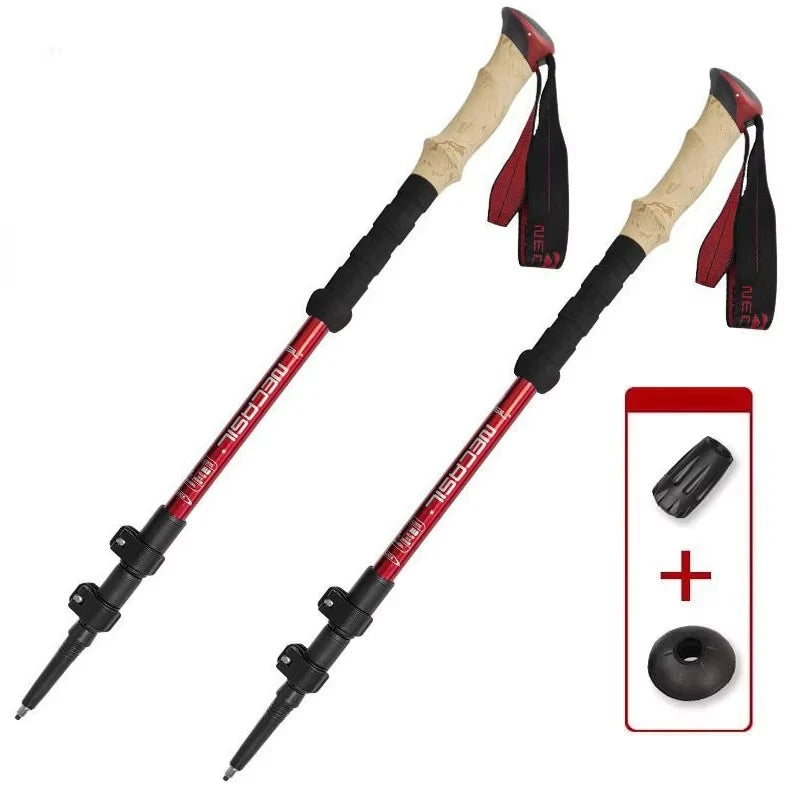 Two red and black trekking poles with beige grips and wrist straps, shown on a white background with an inset showing a black tip and black foam pad accessory.