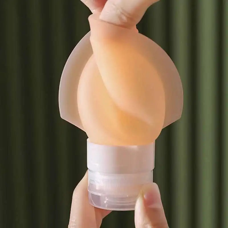Person holding a light bulb-shaped object against a green curtain background
