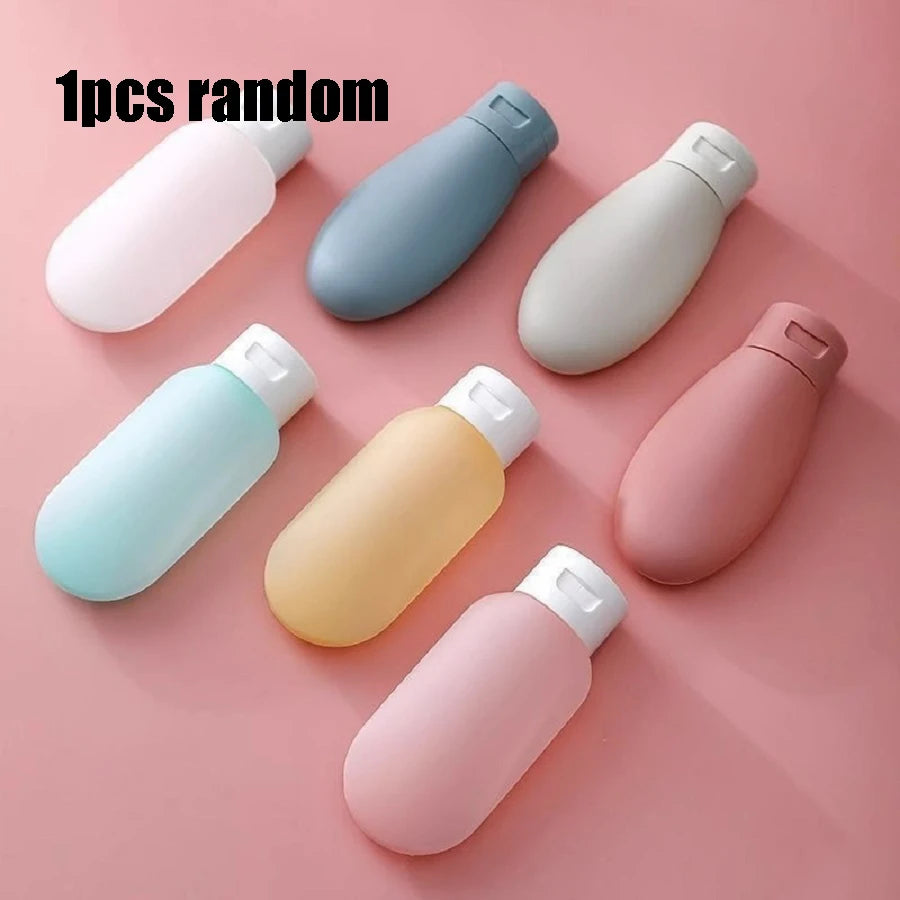 Set of colorful travel bottles on a pink background with text '1pcs random'.