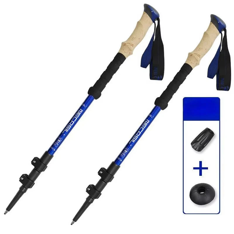 Two blue hiking poles with cork grips on a white background